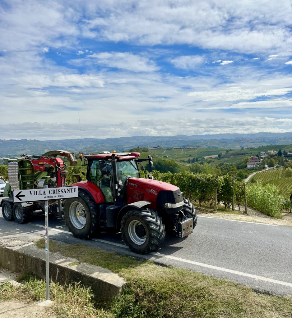 red tractor on a narrow road near la morra italy in langhe region