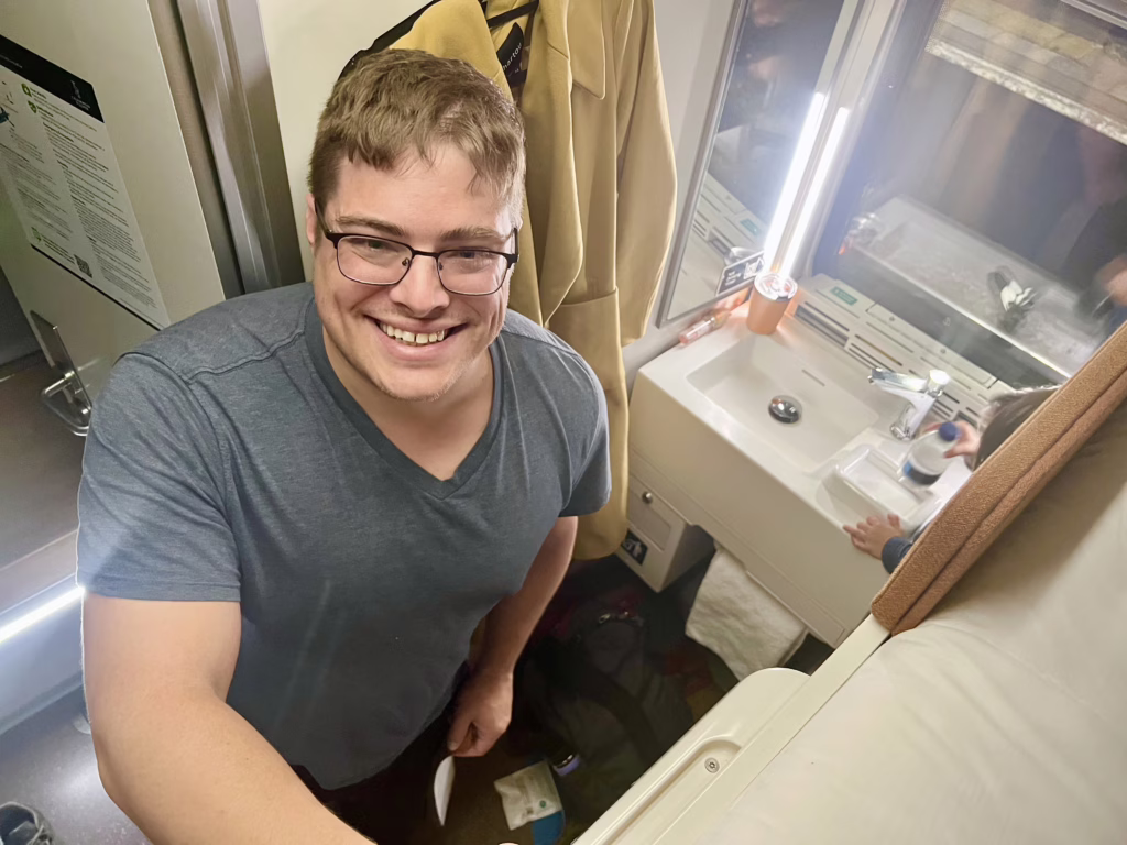jeremy storm standing in the club en suite cabin on the caledonian sleeper overnight train journey from london to scotland
