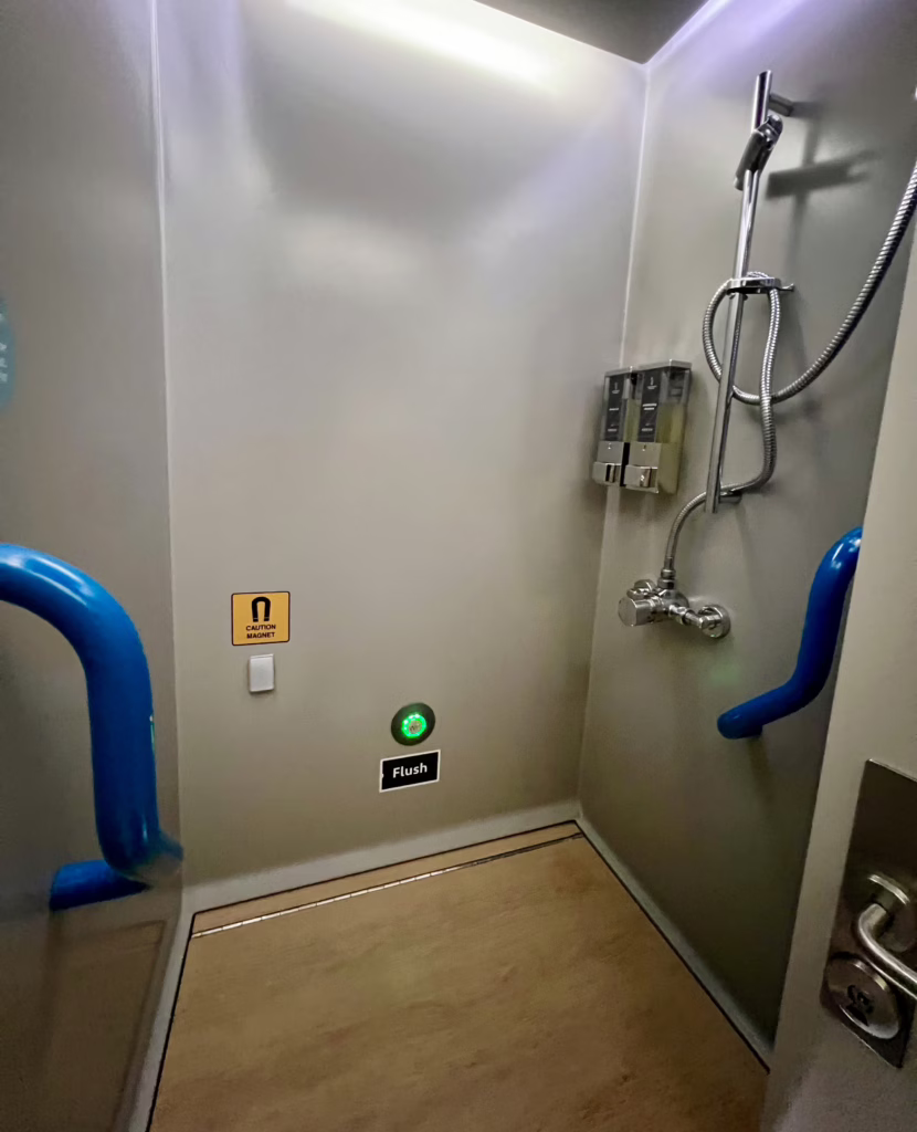 bathroom with a shower onboard the caledonian sleeper in an en suite room