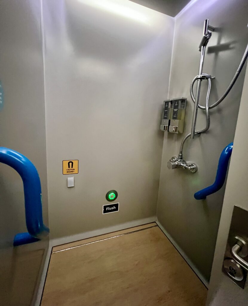 bathroom with a shower onboard the caledonian sleeper in an en suite room