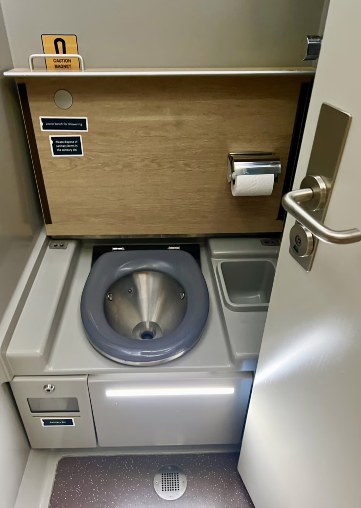 toilet of the caledonian sleeper en suite room shown with the door open