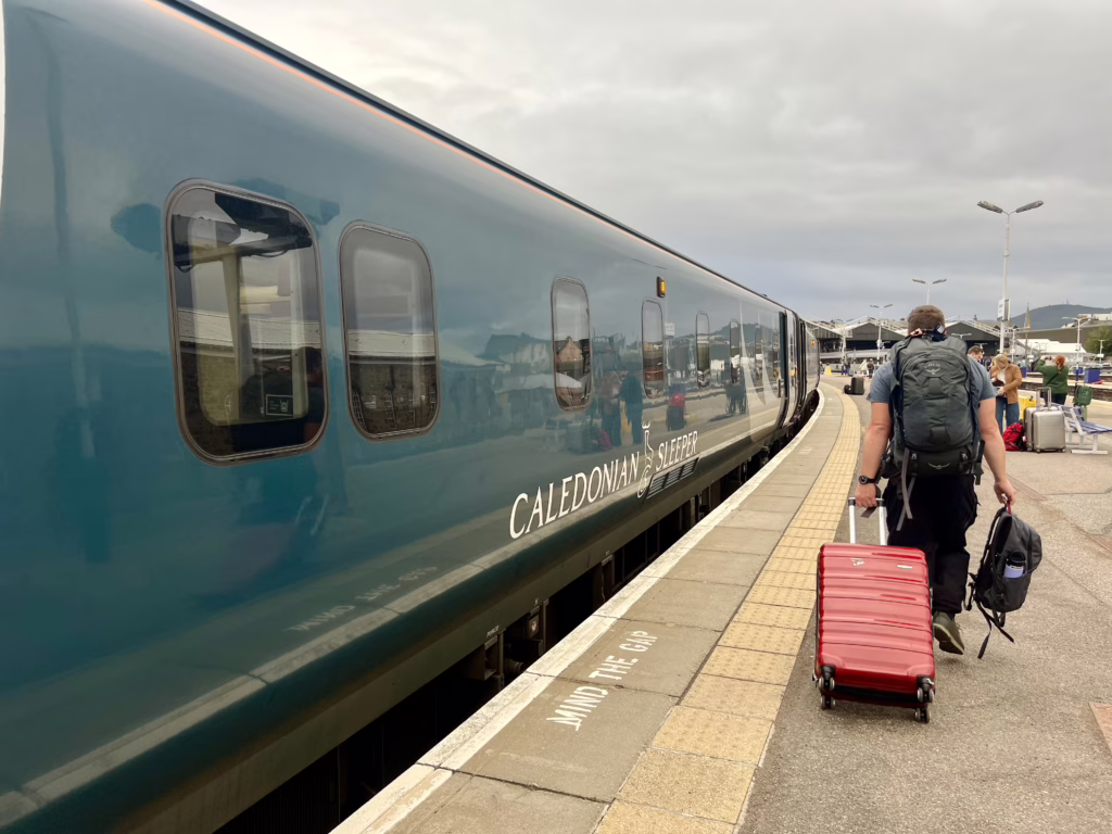 jeremy storm walking off the platform after deboarding the caledonian sleeper train