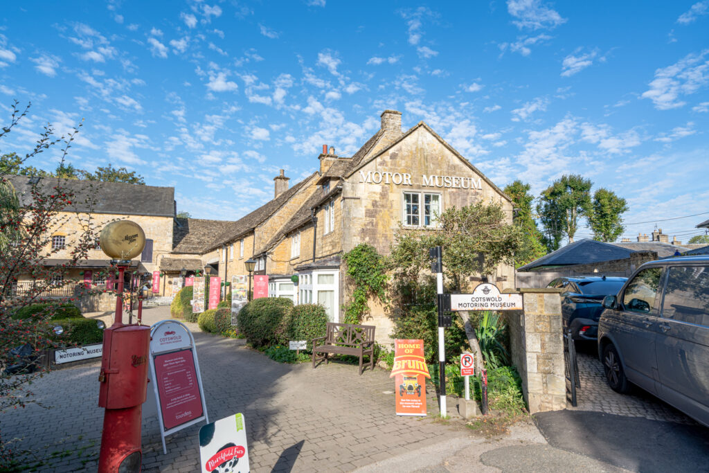 front facade of the cotswold motoring museum in bourton on the water village on a sunny day