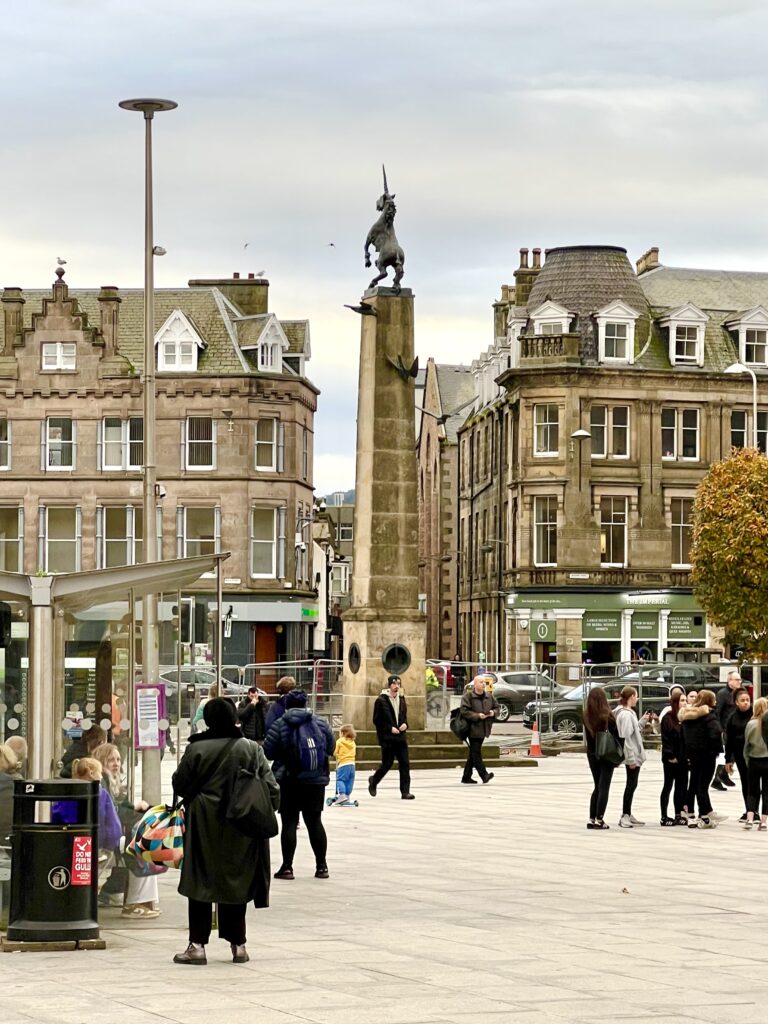 city center of inverness scotland with a unicorn statue in the middle of a square