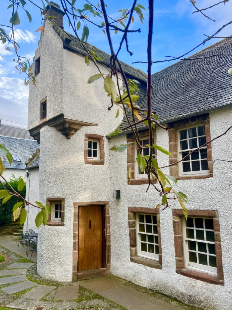 front facade of the white abertaff house on a sunny day, the oldest residential building in inverness scorland trip planning