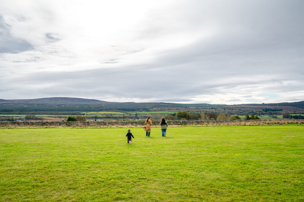 kate storm her son and her friend walking across culloden moor on a cloudy day when visiting inverness scotland