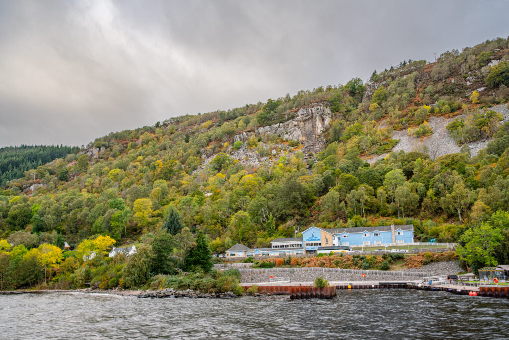 view of the blue clansman hotel in drumnadroicht as seen from a cruise on loch ness