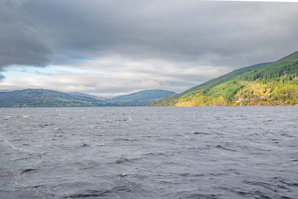 views across loch ness as seen from a boat with clouds in the sky