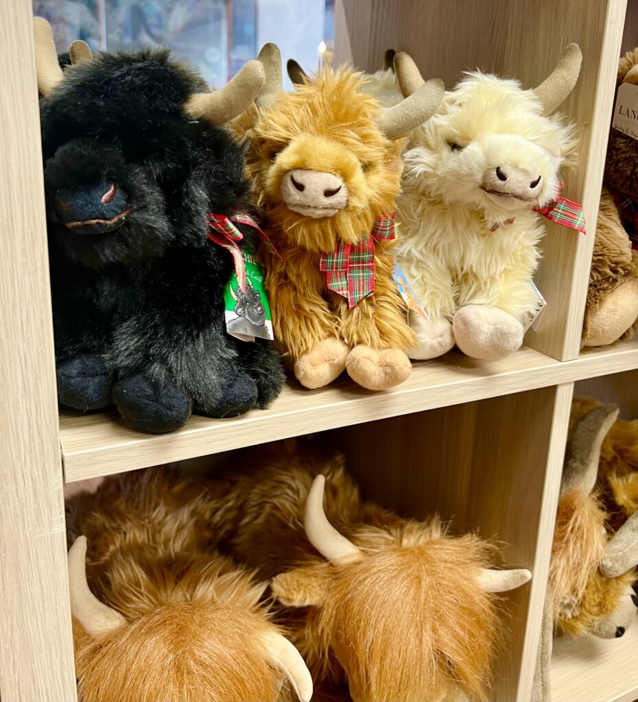 collection of hairy coo stuffies for sale as seen when shopping in scotland