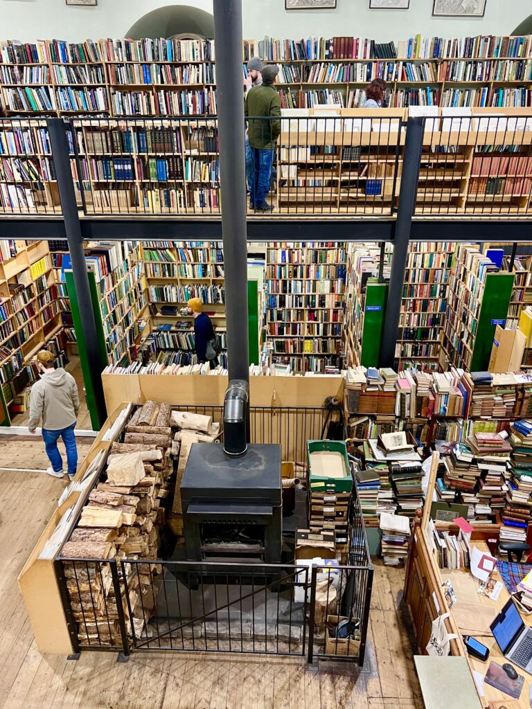interior view of leakeys bookstore scotland seen from above with wood stove centered in the image