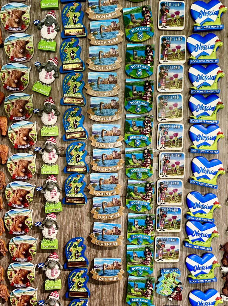 collection of various magnets for sale as souvenirs from scotland gift shop