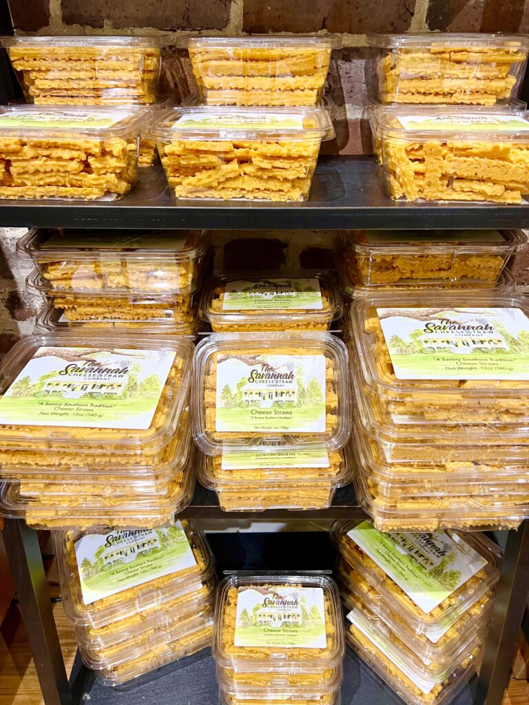 shelves of savannah cheese straws for sale in plastic containers, one of the best things to buy in savannah ga