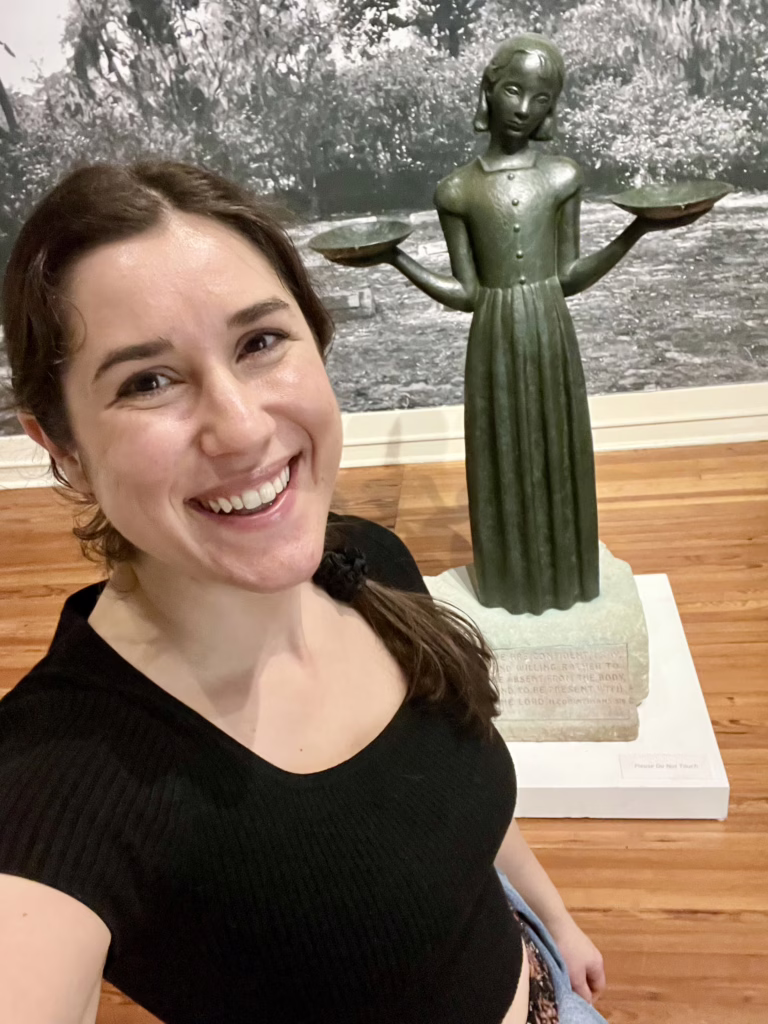 kate storm taking a selfie in front of the bird girl statue in savannah ga telfair museums