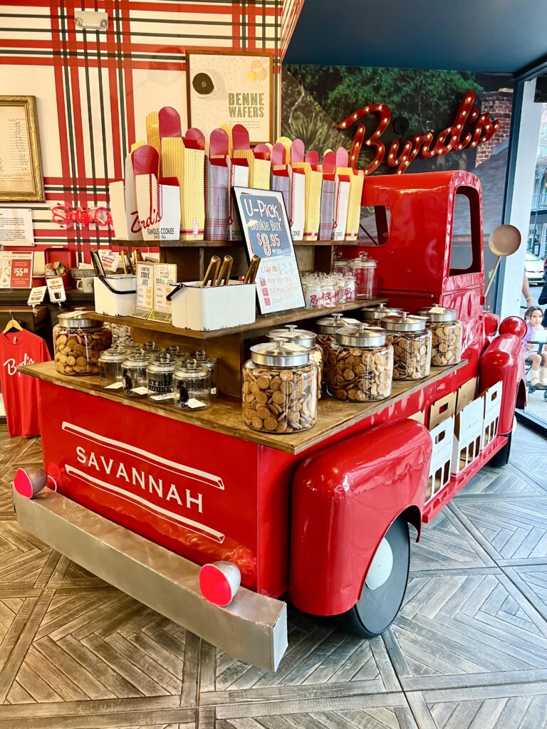 old fashioned red truck parked in byrds cookies as seen when shopping in savannah georgia on broughton street, truck is stacked with cookies for sale