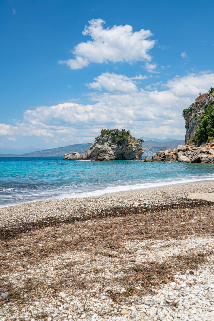 view of mirror beach albania showing the seaweed that is prevalent onshore