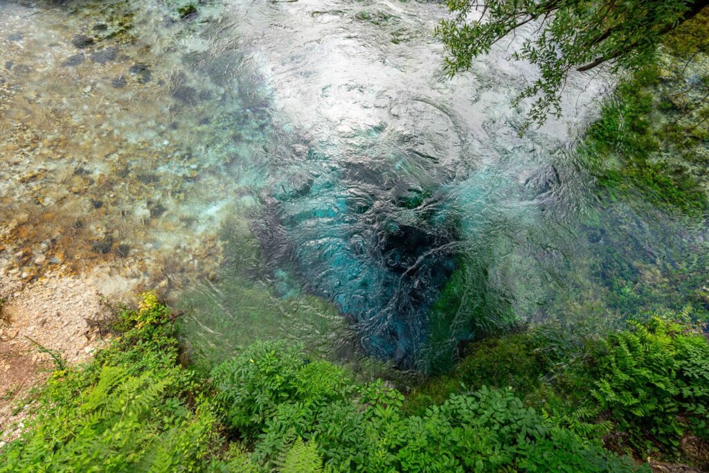 close up shot of the blue eye of saranda from above, one of the best things to see in albania