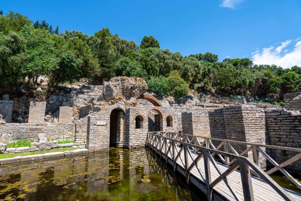 view of Asclepius' sanctuary at butrint albania with water and bridge in the foreground and ruins in the background