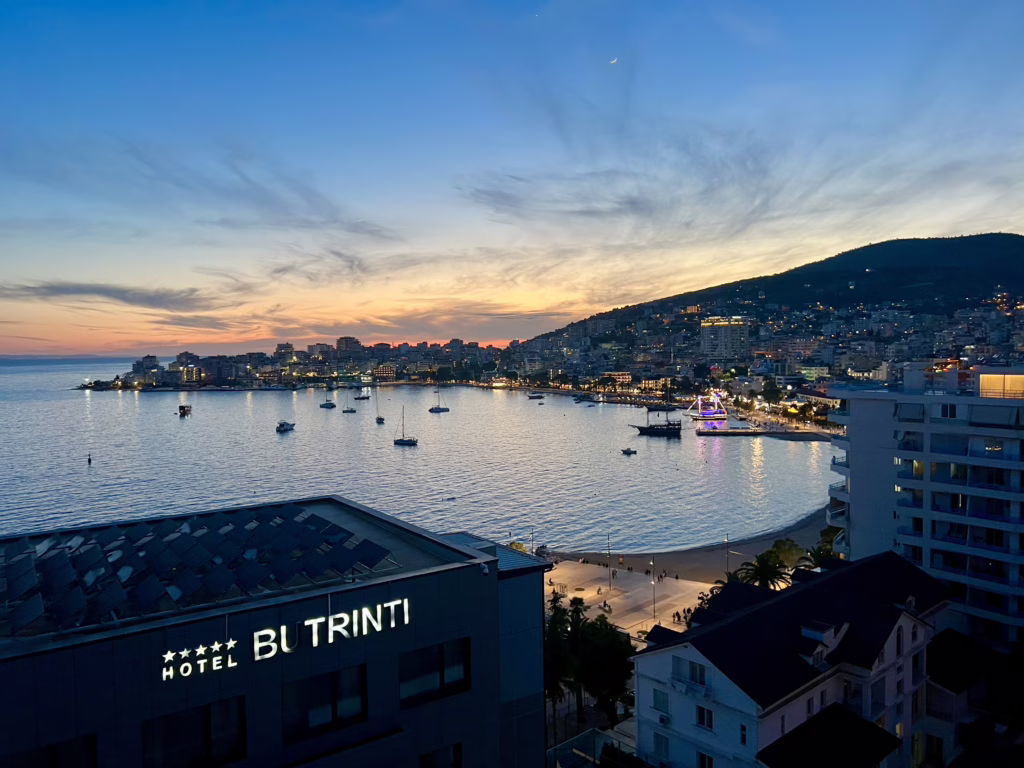 view of saranda at sunset from above, taken from a balcony at sea crest apartments