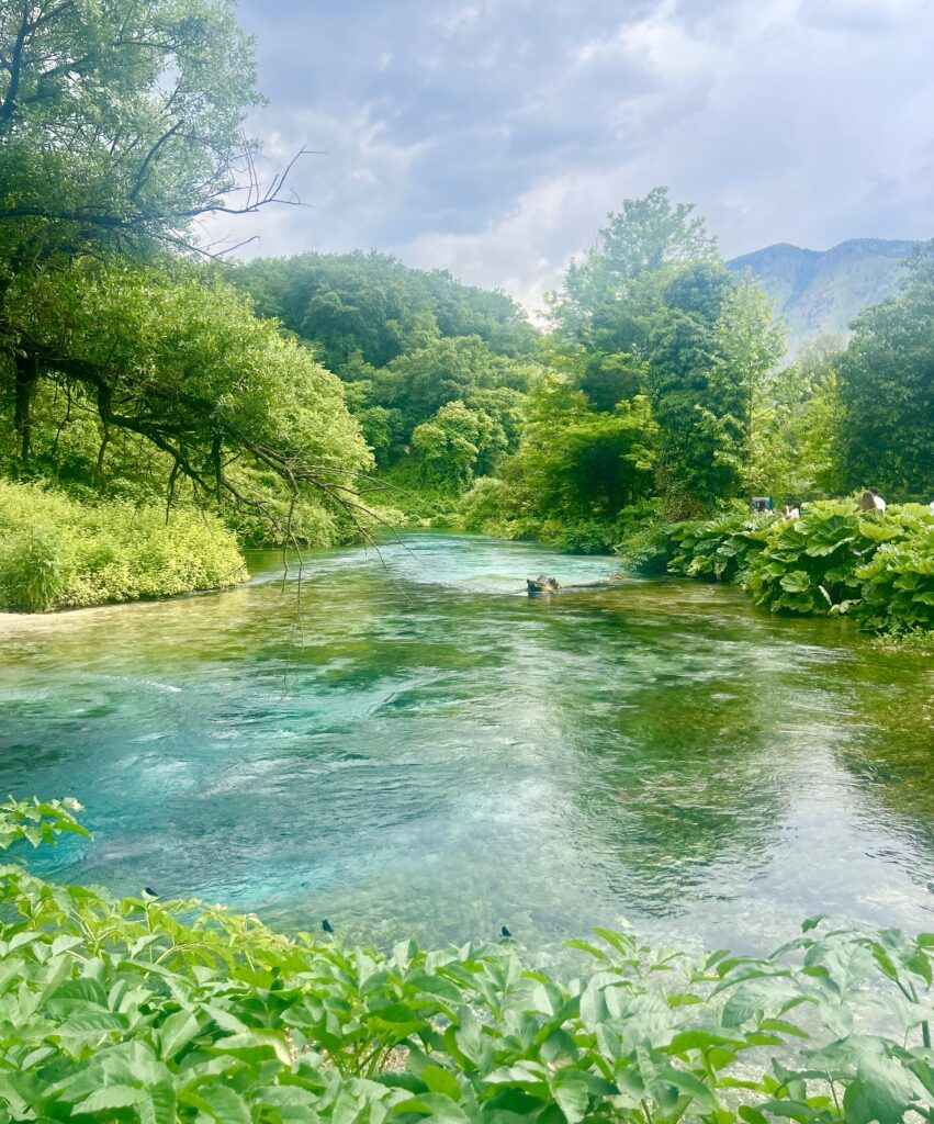 view of the water near the blue eye of saranda as seen when approaching the viewing platform