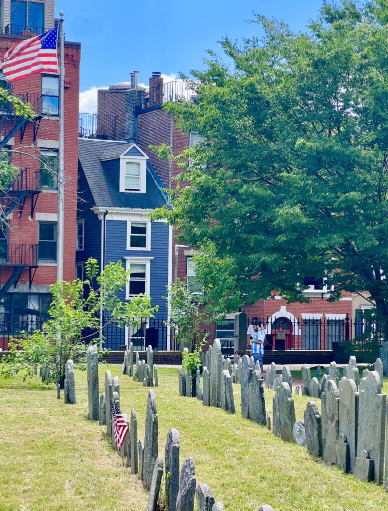 view of the spite house as seen from copp's hill burying ground with stones in the foreground, one of the best things to do boston north end neighborhood
