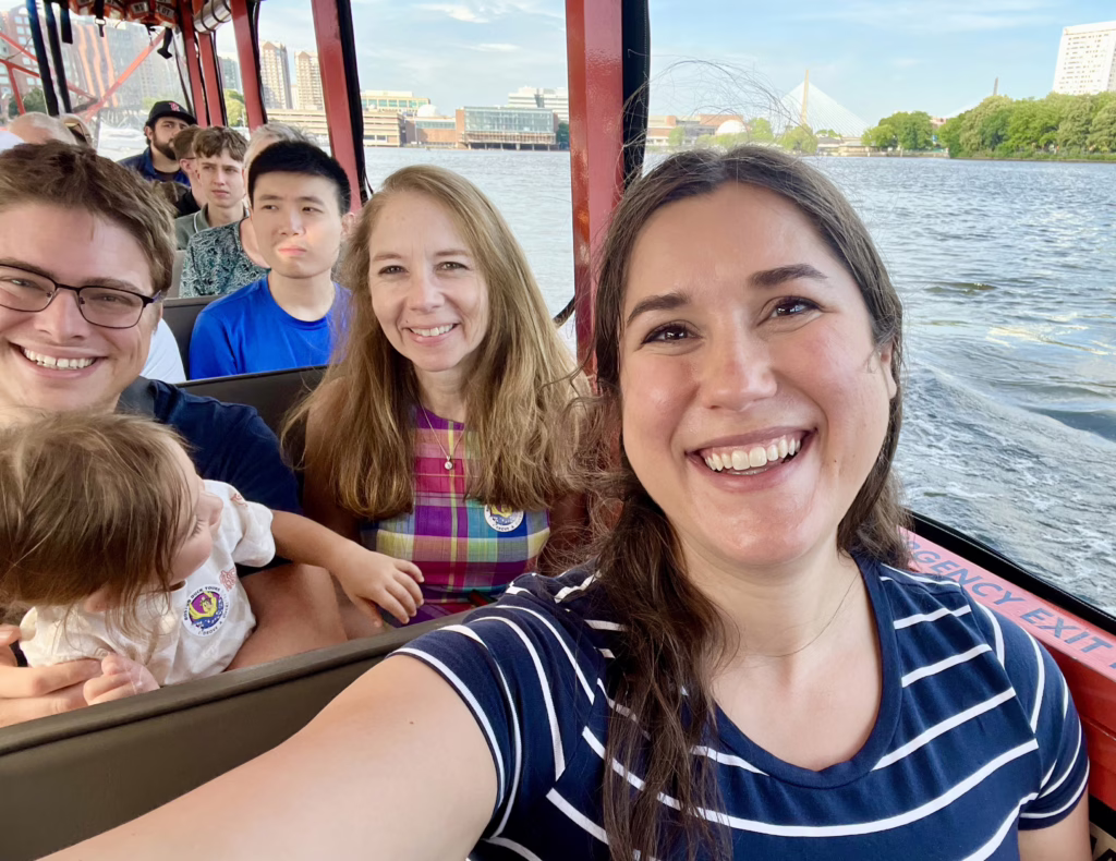 kate storm, jeremy storm, their toddler and stepmon taking a selfie on the charles river during a duck tour in boston massachusetts