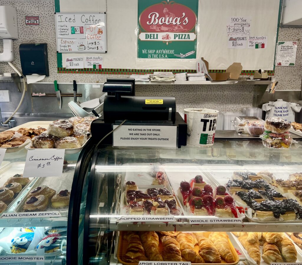 interior of bova's bakery in boston north end with pastry display cases taking up most of the frame