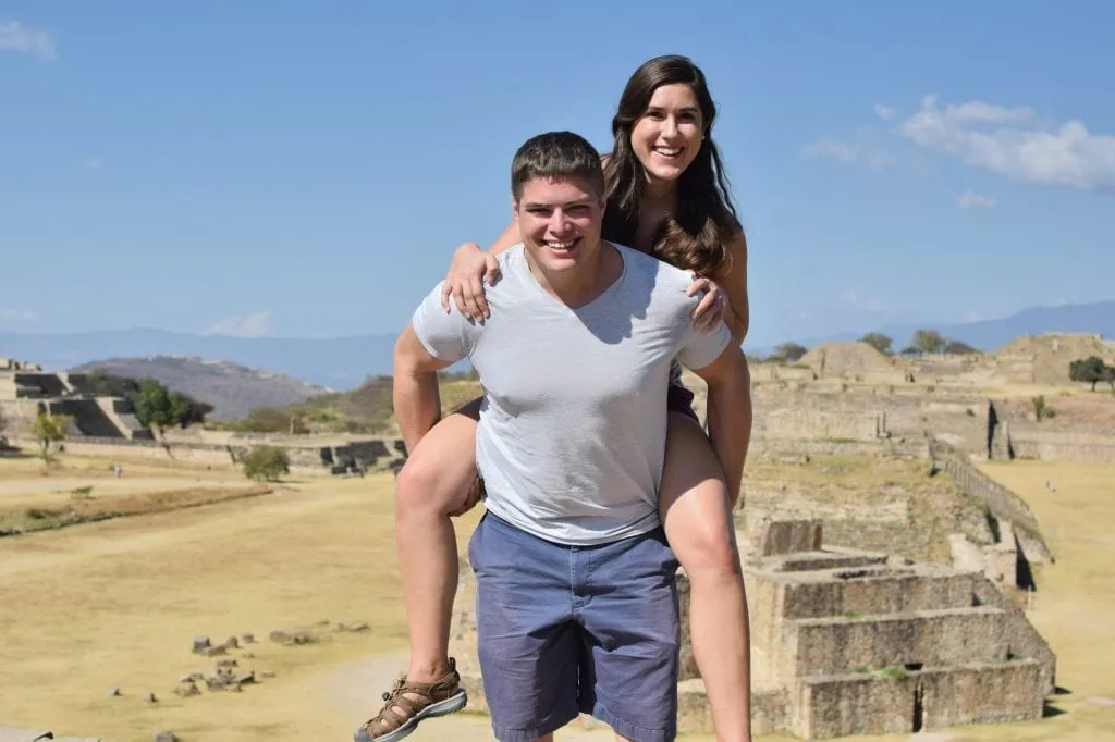 Kate Storm and Jeremy Storm at Monte Alban in Oaxaca Mexico--exploring lots of ruins like this is one of our top tips for traveling to Mexico!