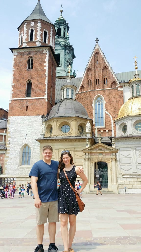 Kate Storm and Jeremy Storm standing in front of Wawel Cathedral when visiting Krakow Poland