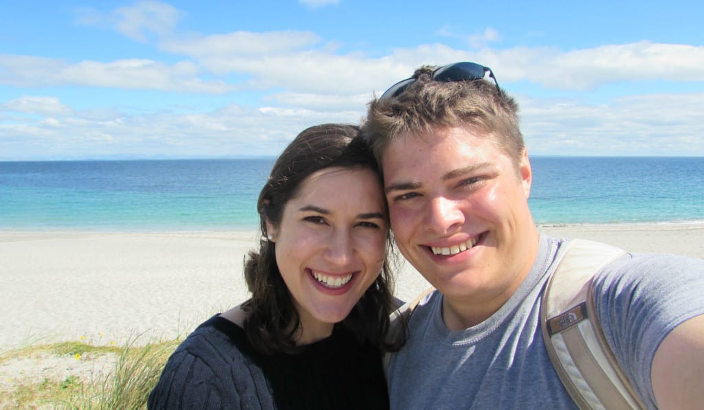Selfie of Kate Storm and Jeremy Storm in front of a turquoise beach on Inisheer Island Ireland
