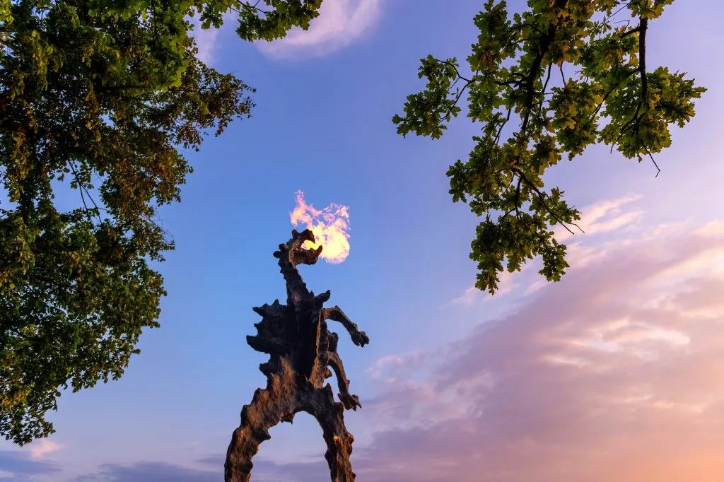 wawel castle dragon breathing fire at sunset