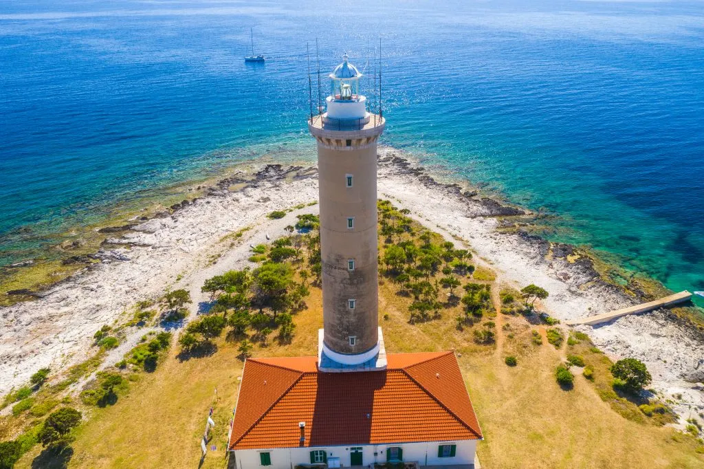 beach on dugi otok croatia near zadar with lighthouse in the foreground