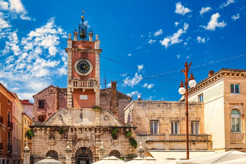 pink clock tower in peoples square as seen from the front, one of the best places to visit zadar croatia