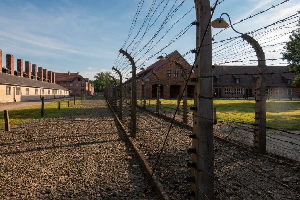 barbed wire fence surrounding auschwitz concentration camp