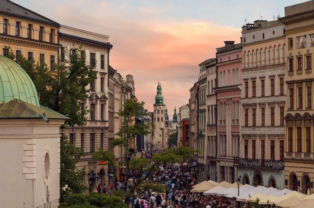 Crowded Grodzka Street in Krakow Poland near sunset with buildings lining either side of the photo