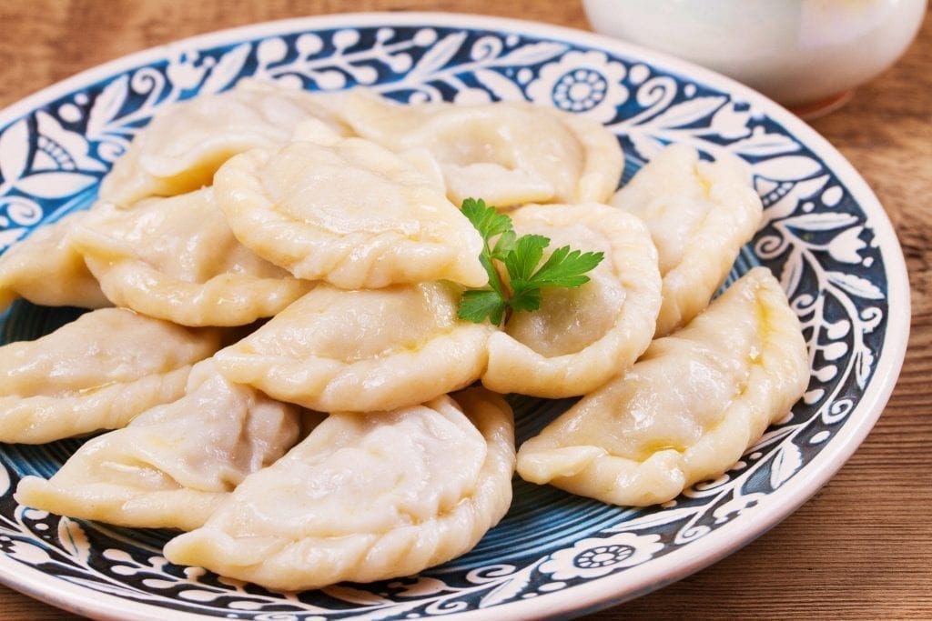 Plate of pierogi on a blue and white patterned plate