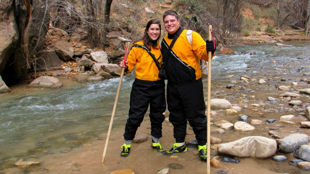 Kate Storm and Jeremy Storm wearing dry suits to hike the Narrows in Zion National Park