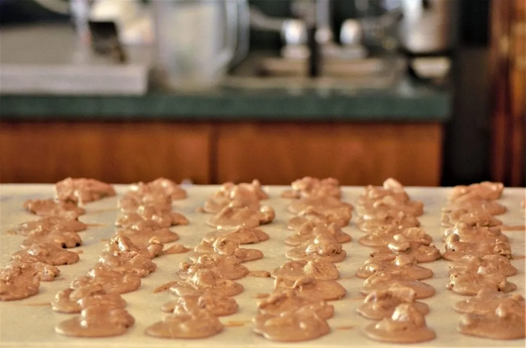 Southern pralines cooling on a countertop, one of the best things to eat in Savannah GA shutterstock_1623155815