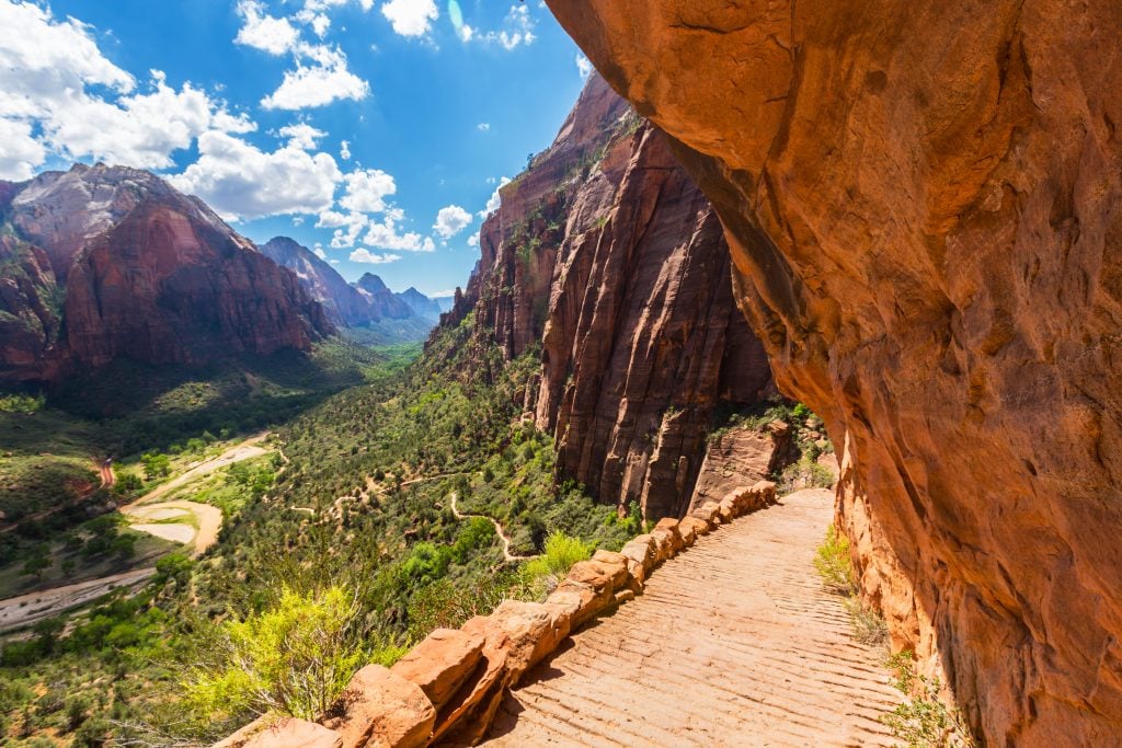 view from angels landing trail with zion canyon to the left and a rock wall to the right, one of the best hikes in zion national park