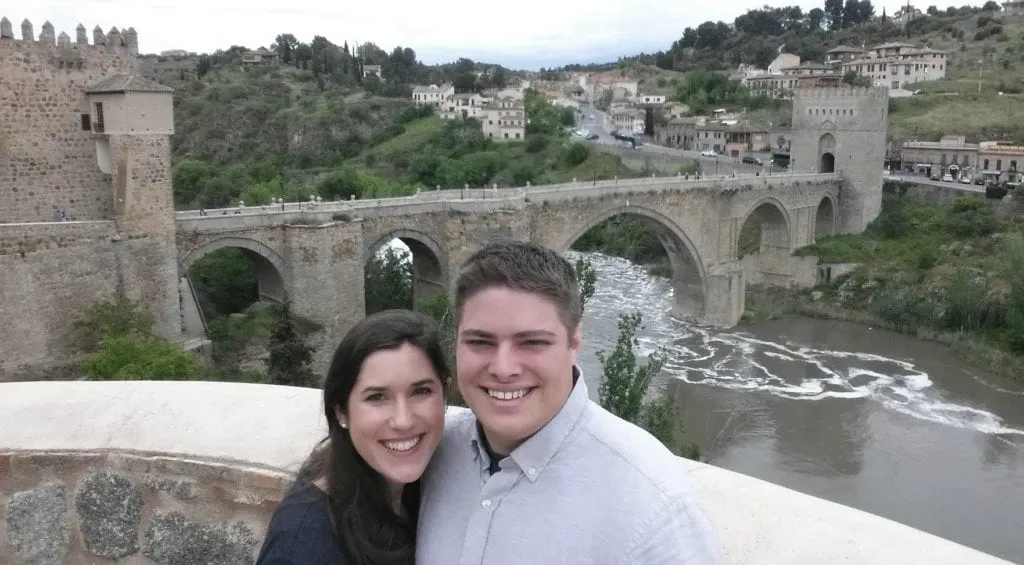 Kate Storm and Jeremy Storm taking a selfie with San Martin Bridge during one day in Toledo Spain