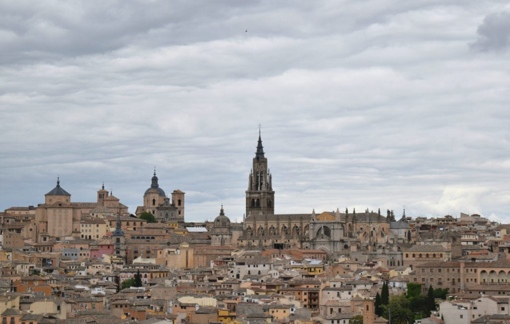 View of the roofs of Toledo from across the Tagus River, as seen on a Madrid to Toledo Day Trip on a cloudy day