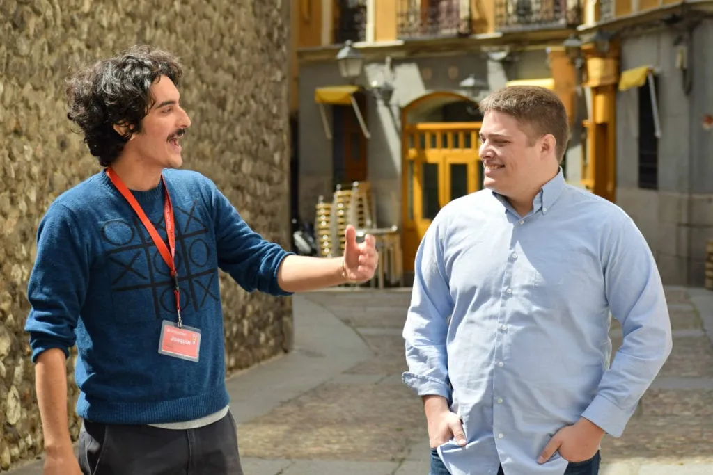 jeremy talking to a tour guide on a free madrid walking tour, an inexpensive part of our madrid travel budget costs