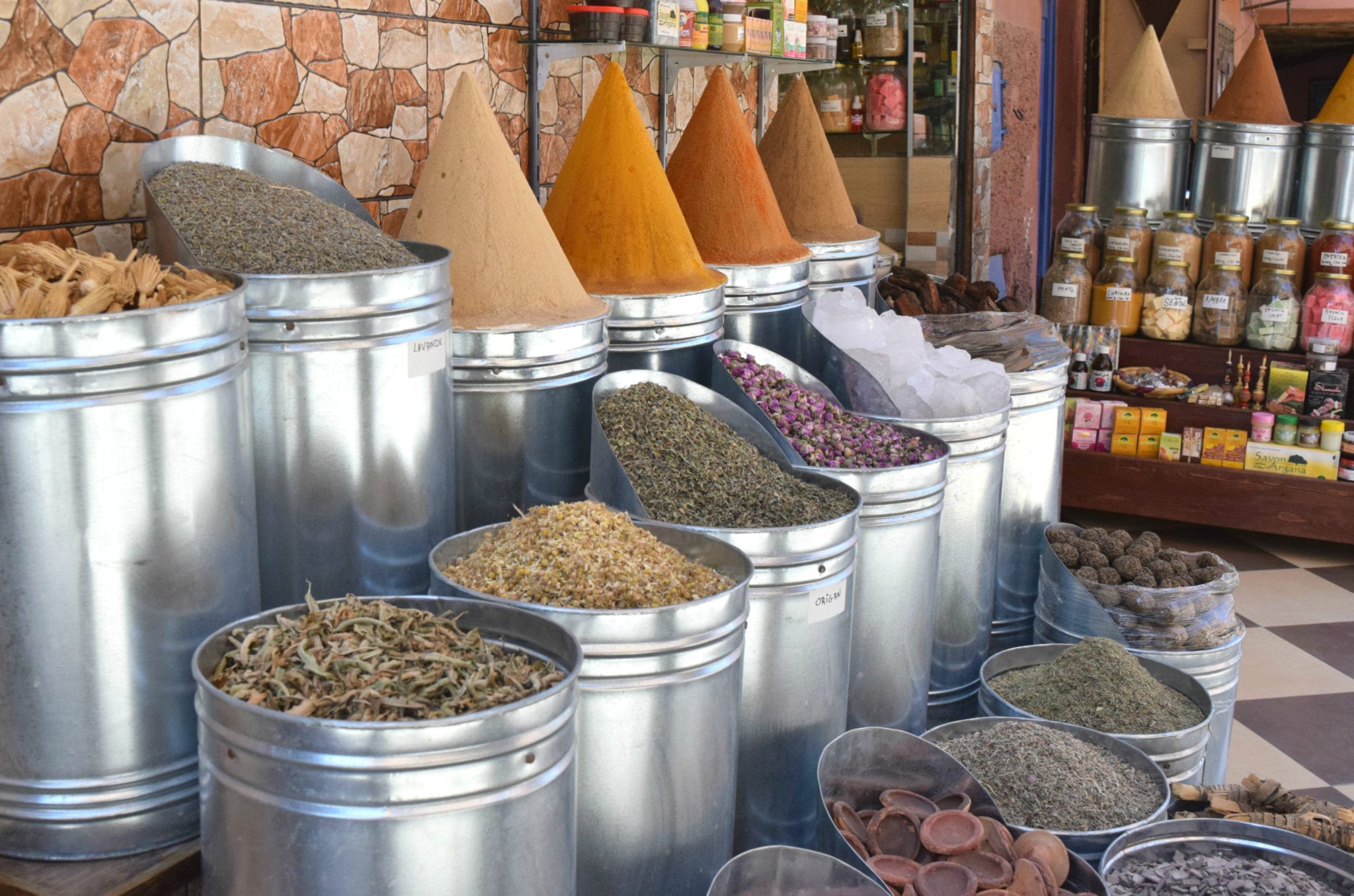 piles of spices in marrakech medina--spices are an affordable addition to trip to morocco costs and a morocco travel budget