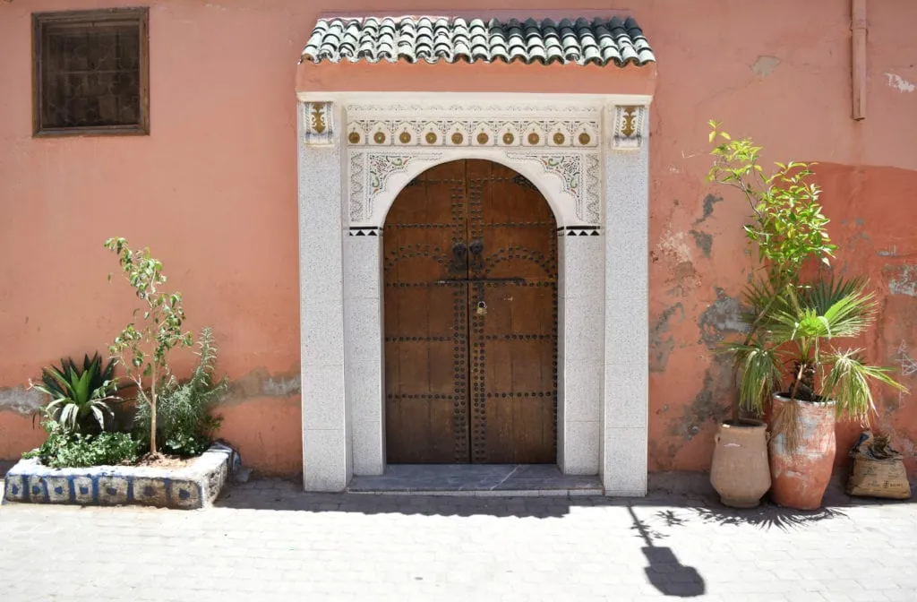 moroccan door in marrakech surrounded by white detail
