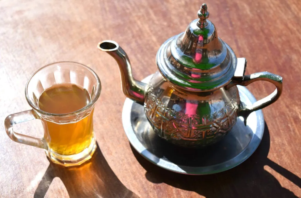 moroccan teapot and teacup on a wooden table