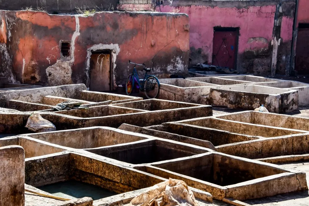 marrakech tannery as seen from above with pink and orange buildings in the background