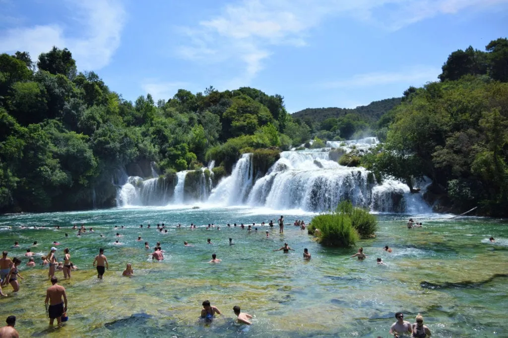 people swimming in waterfalls croatia krka vs plitvice national park