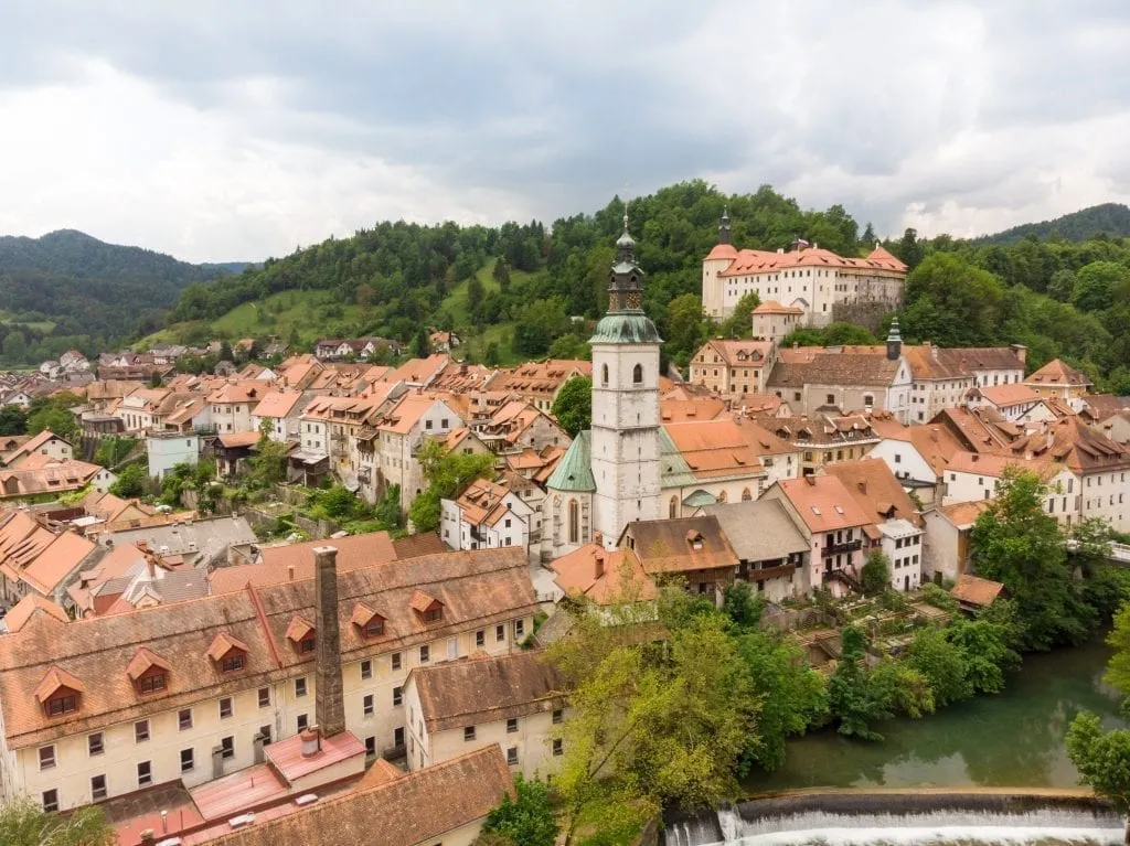 Cityscape of Skofja Loka from above with castle visible in the background, one of the best places to visit in Slovenia