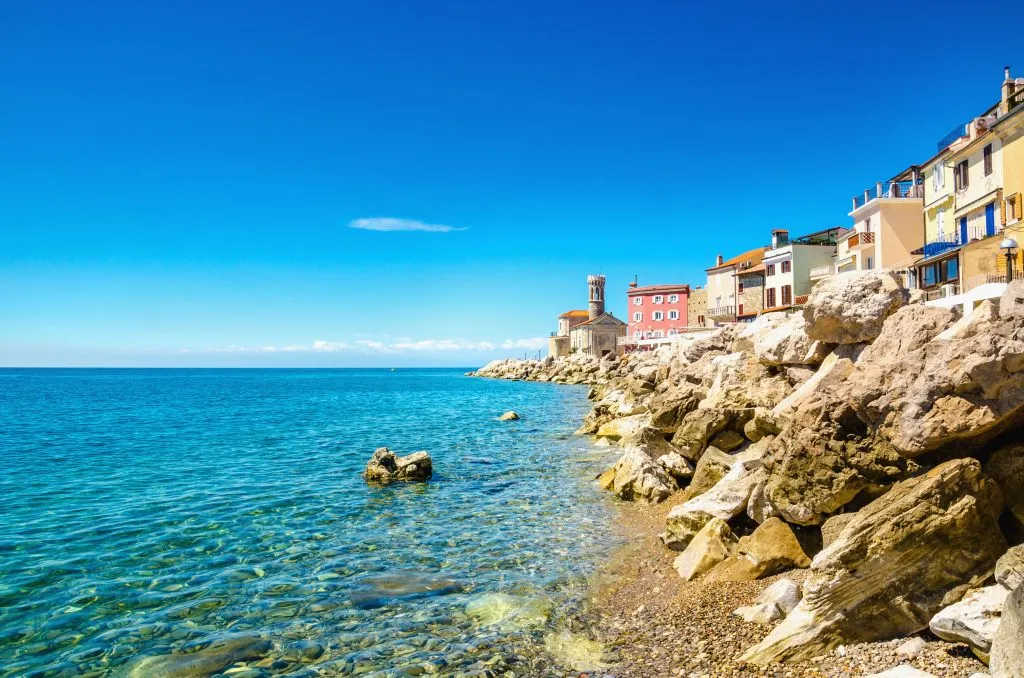 view of piran slovenia coastline with lighthouse in the background