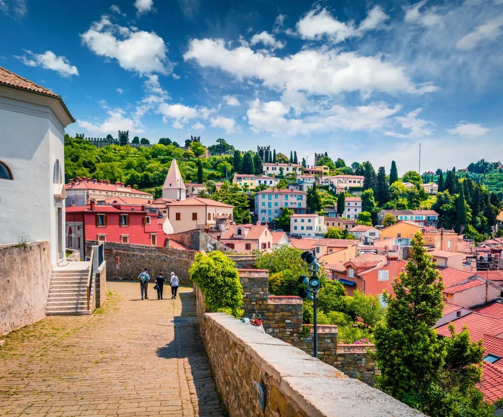 view of buildings of piran slovenia seen near st georges church, one of the best things to do in piran slovenia