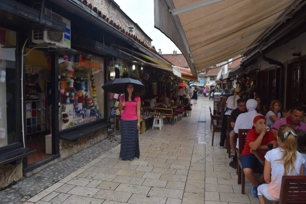 kate storm holding an umbrella when exploring old town, one of the best things to do in sarajevo